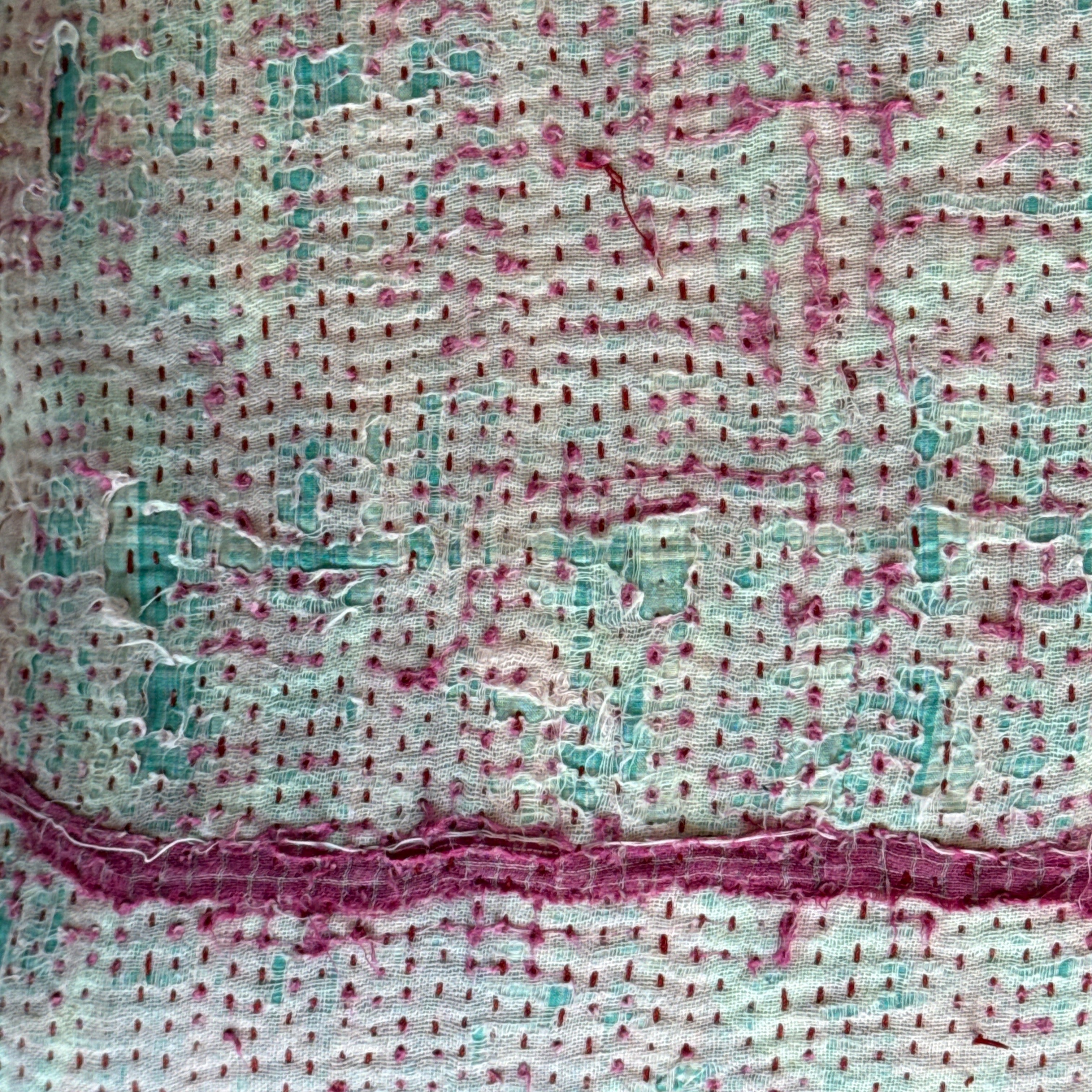 close-up of kantha pillows pink