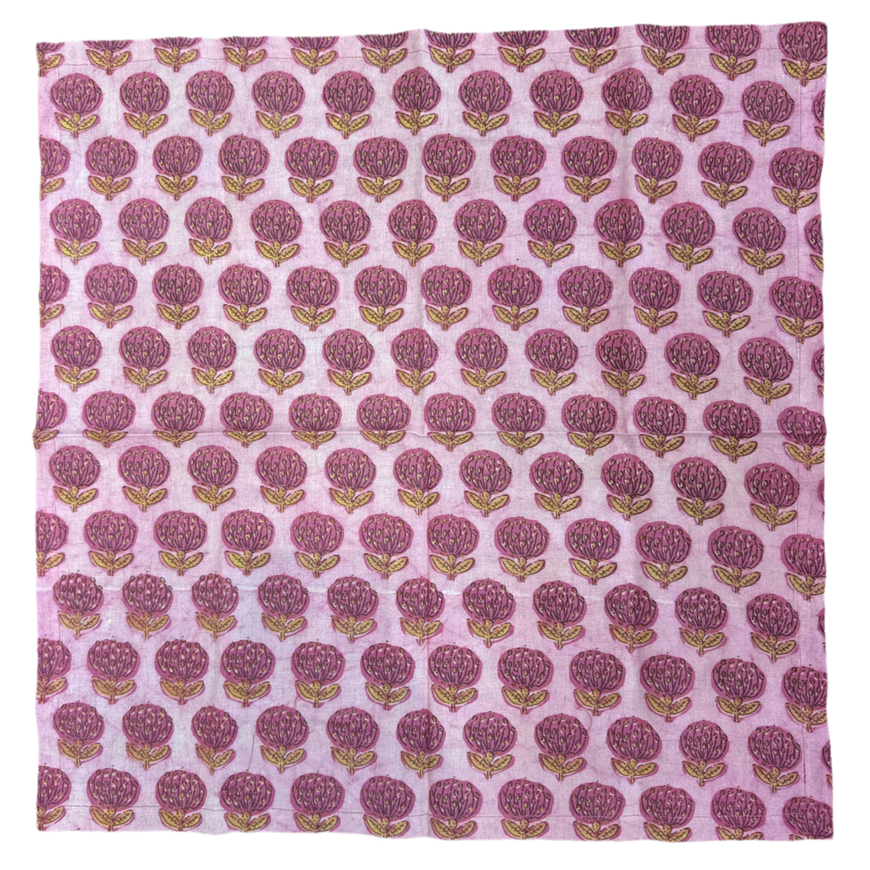 Fabric with a pink and purple pattern on a wooden surface