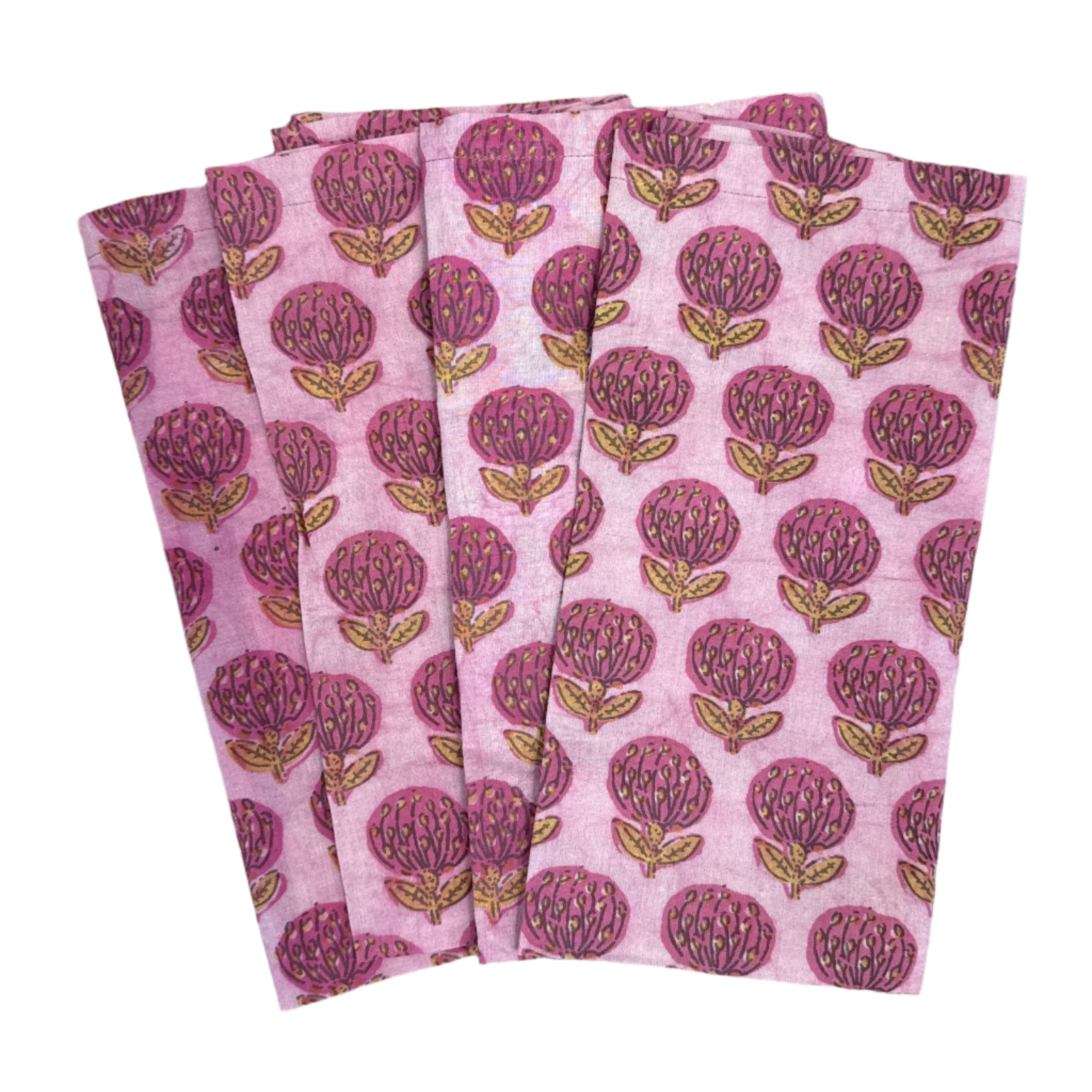 Folded pink fabric with a pattern of red apples on a wooden surface