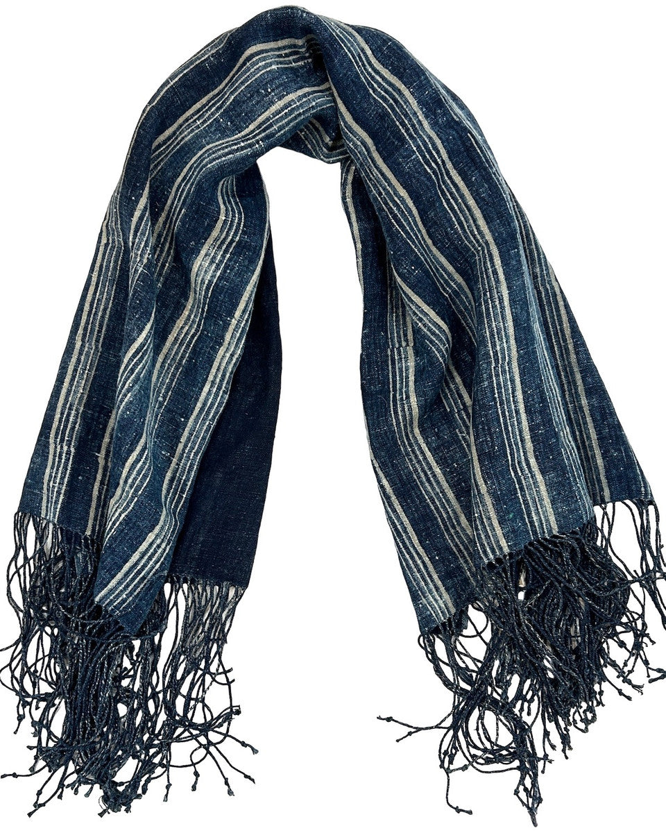 Handwoven indigo dyed linen throw. This lush throw has a beautiful striped indigo pattern that was dyed in an 'abrash' method. The back side is solid dark indigo. This is a heavy linen throw that would be beautiful on the end of a bed or on the couch.