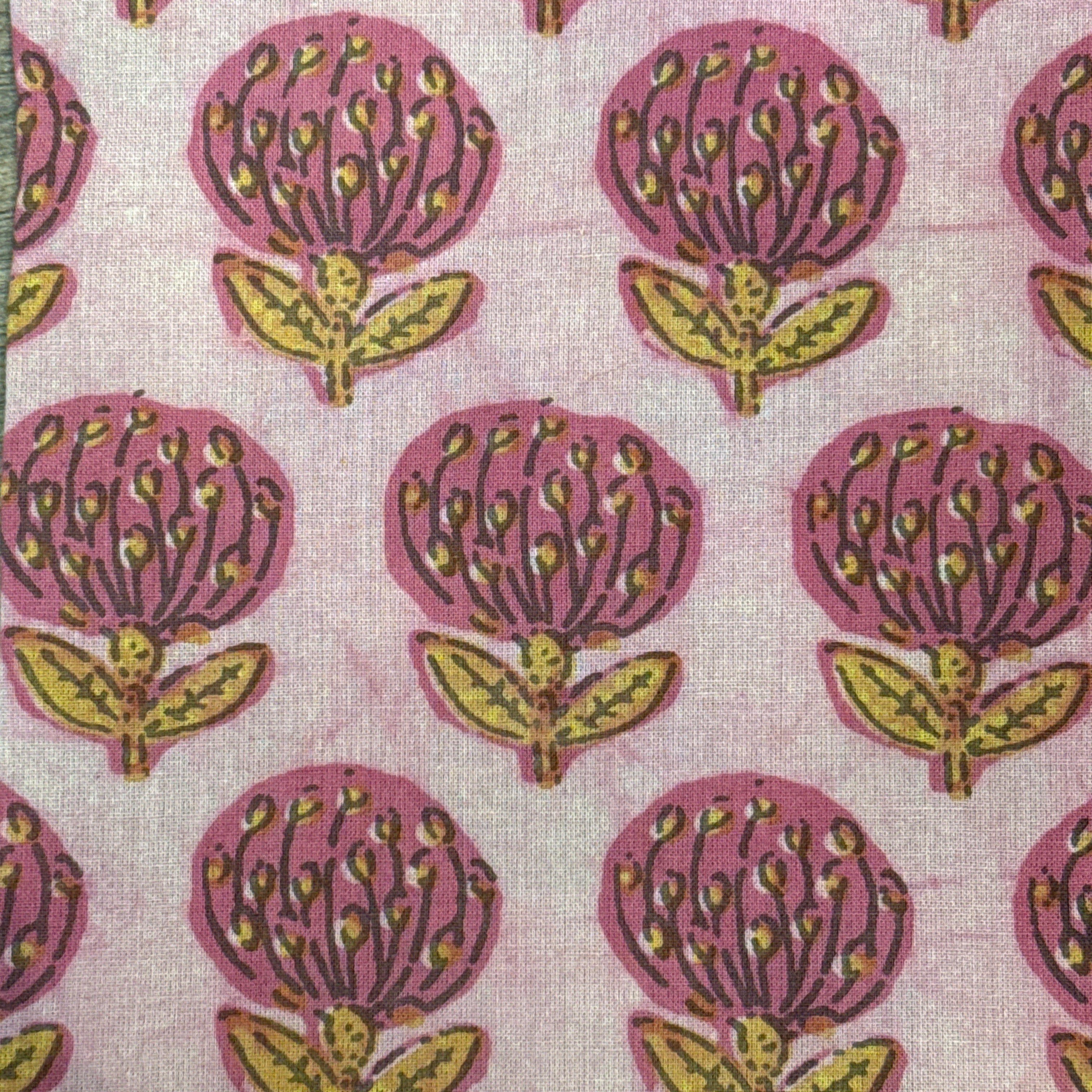 Block printed napkins India Patterned fabric with pink and yellow floral design on a light background