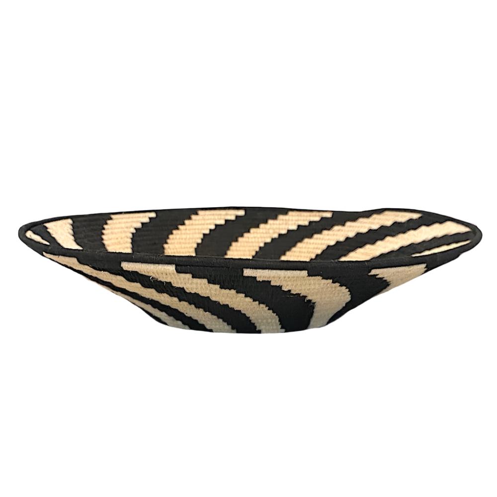 Handwoven fiber basket made with natural sisal from sustainably harvested sources. This is from a small artisan organization that has been working in Eswatini (Swaziland) since 1985. Very sturdy. Beautiful on the table or on the wall. Colors: cream and black.