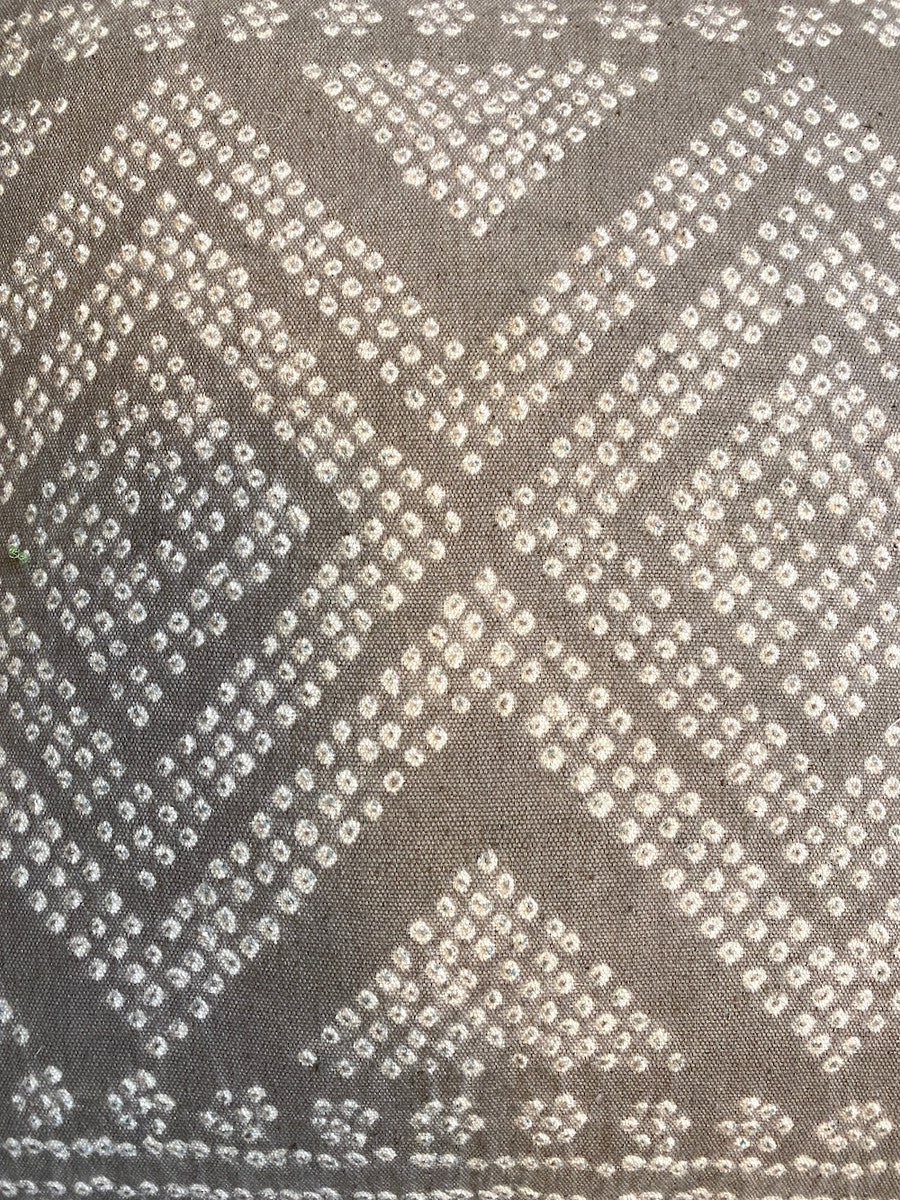 detail Organic Cotton Bandhani (tie dyed) pillow India Colors: white and light taupe color. White piping and the back is a solid light taupe cotton fabric.