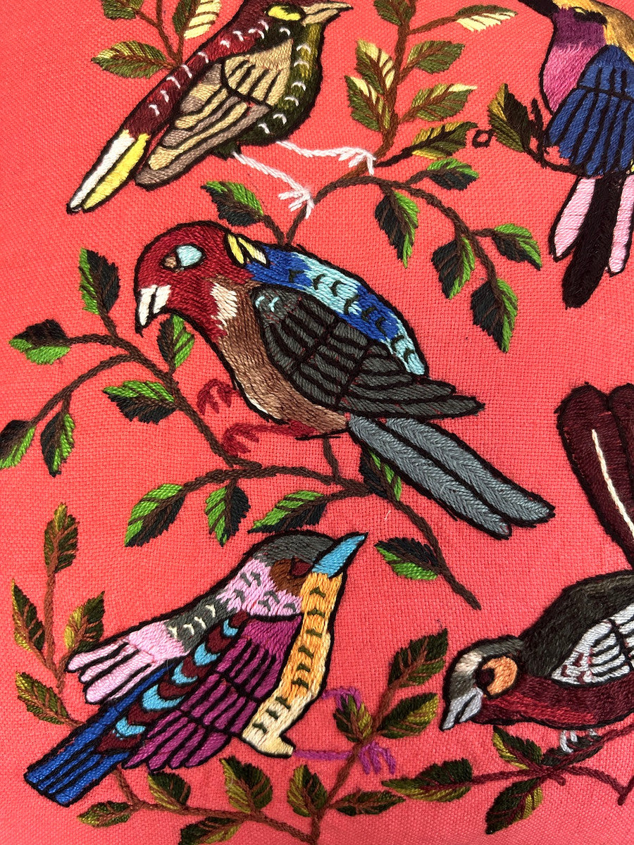 detail he pillow handwoven peachy pink colored cotton cloth. Each bird is unique-so allow for some variations. The back and hand rolled piping are a burgundy colored linen cloth. The birds are many bright colors with a black outline. The branches and leaves various greens and browns with some burgundy. Hidden zipper with 90-10 feather/down pillow insert.