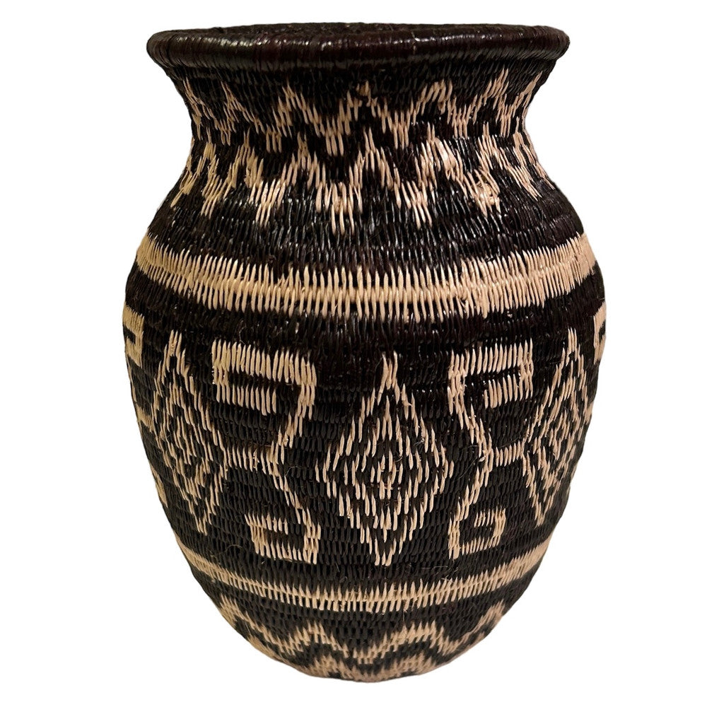 This small fine basket is made from natural palm fronds cut into fine strips. The sturdy basket is woven with a complex technique and with a fine tight pattern. The Wounaan women are considered the finest basket makers in the world. Through basketry they help preserve their culture and in so doing they respect the earth with sustainable harvesting practices. Colors: black, and wheat.