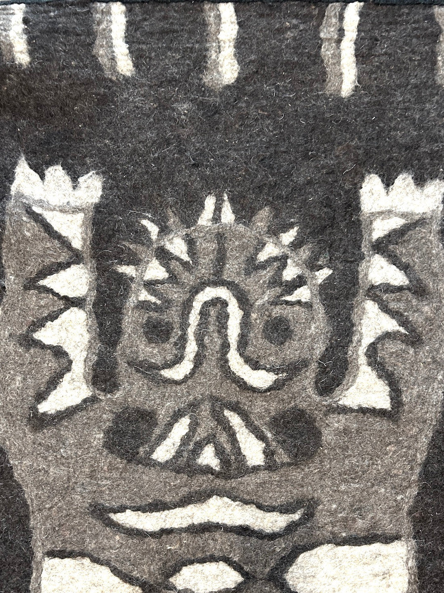 detail. Handmade Wool Felt Tiger Runner Rug 1 Afghanistan The tiger is heathered grey, heathered oatmeal and charcoal. The rug is heathered charcoal. There is a black woven border sewn around the whole rug.