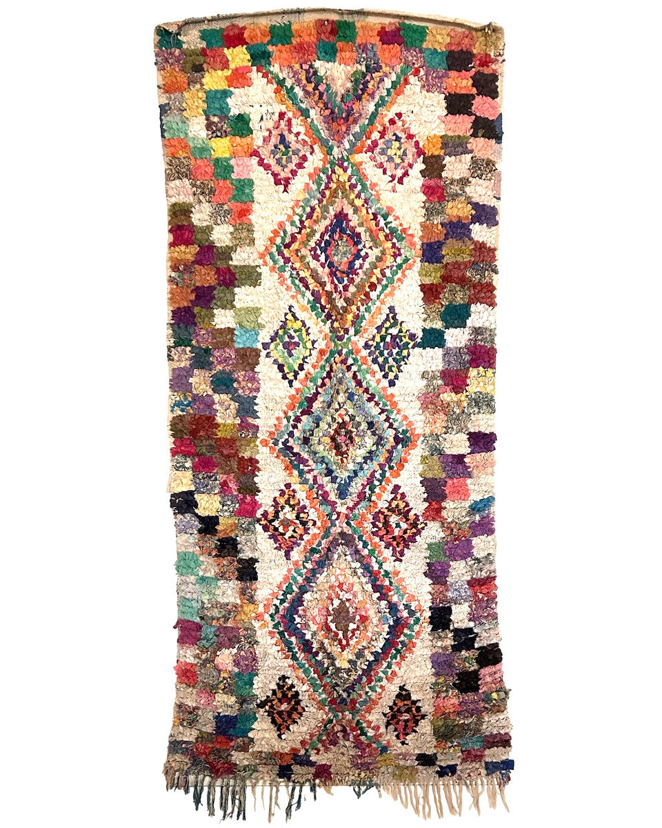 This vintage hand knotted one-of-a-kind boucherouite from outside of Marrakech. Cotton and mixd fabrics make up the pile rug. This rug would add a shot of color to your decor and would look great as a wall hanging, too. A medley of colors
