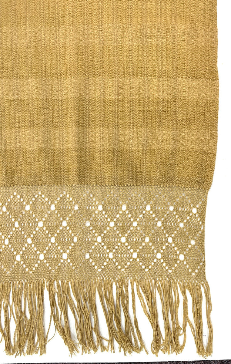 detail Beautiful traditional rebozo by master weavers Aurelia Jiménez and Bonifacio Pacheco of the Rebozo Mexiquense Academy in Tlahuitoltepec, Mexico. The Mexiquense Academy was founded to preserve the rebozo weaving and provide jobs to young people in his community. This finely woven rebozos (shawls or scarves), with the signature detailed twined ends, are natural dyed in shades of ochre.