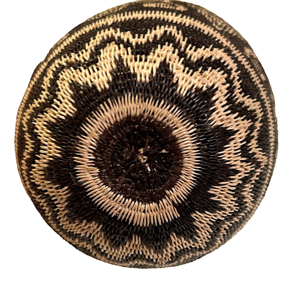 bottom view This small fine basket is made from natural palm fronds cut into fine strips. The sturdy basket is woven with a complex technique and with a fine tight pattern. The Wounaan women are considered the finest basket makers in the world. Through basketry they help preserve their culture and in so doing they respect the earth with sustainable harvesting practices. Colors: black, and wheat. 