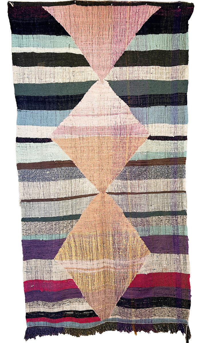 Handwoven rag rug with a dynamic pattern of large diamonds and broad stripes, from weavers in southern Morocco. Beautiful on the floor or on the wall. Colors: shades of pink and peach, pale light blue, sky blue, white, sea foam, purple, deep bright magenta, army green, charcoal, cream, chocolate and more.