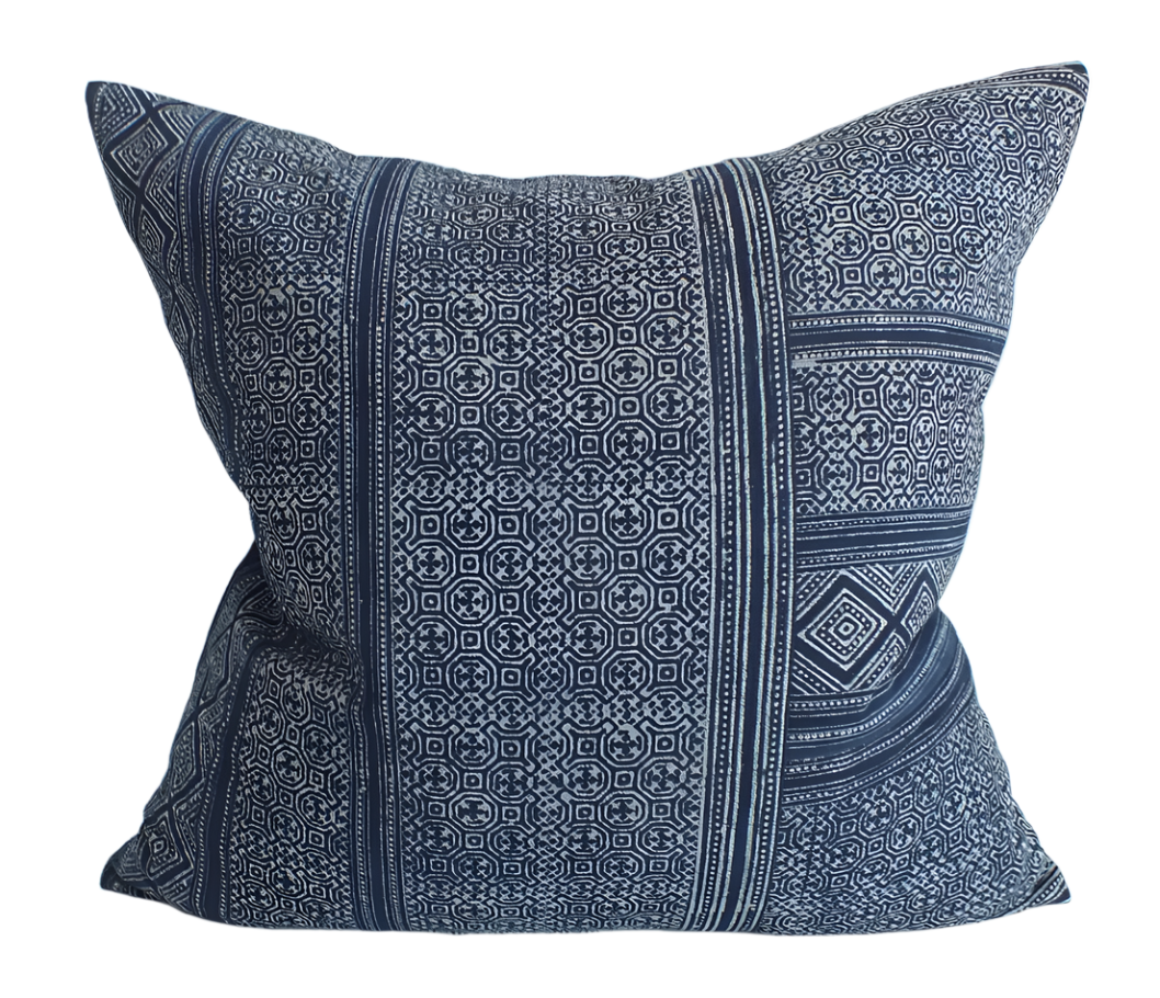 Blue hand block printed patterned pillow on a white background. Batik indigo handmade