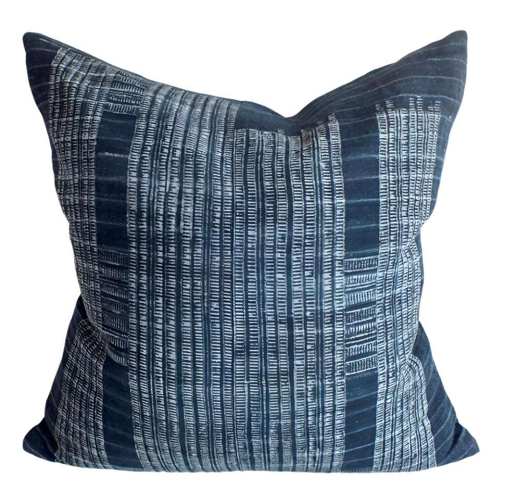 Blue and white patterned pillow on a light background. Indigo block printed vintage batik pillow